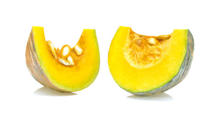 cut piece fresh pumpkin with shell and seeds on white background