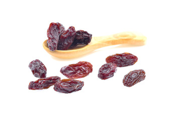 Dried raisins in a wooden spoon on the white background