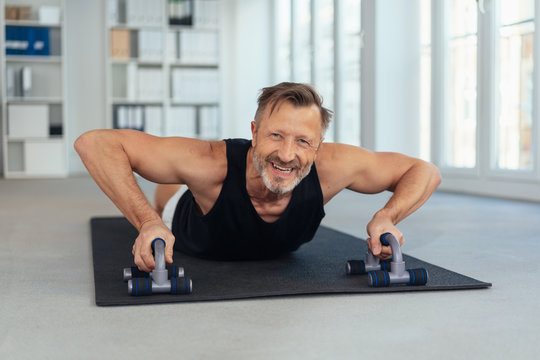 Fit middle aged man working out in a gym