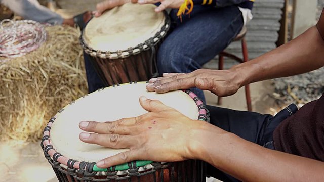 Man hands playing the ethnic drum (tom-tom). Musician playing the ethnic drum. 4K 