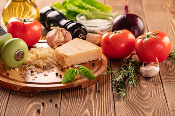Ingredients for spaghetti bolognese with cherry tomatoes and basil on a wooden table