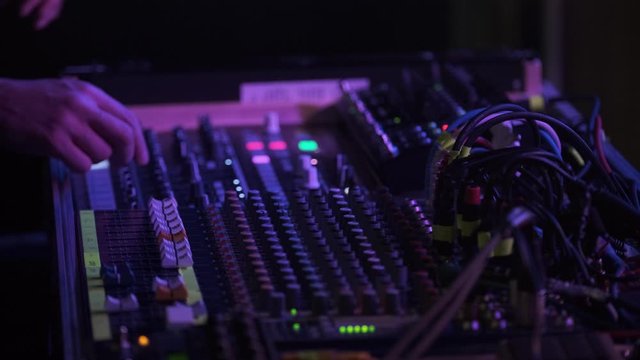 DJs Moving The Faders On The Sound Board In A Dance Party In Toronto, Ontario, Canada - Closeup Shot