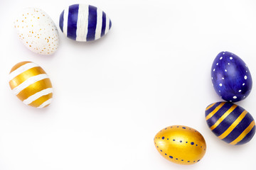 Happy Easter. Frame for text made of easter eggs trendy colored classic blue, white and golden on white. Minimal style, top view, flatlay, copy space