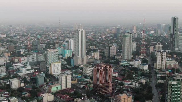 Aerial Drone shot of Cubao in Quezon City, Manila, Philippines while sunrise