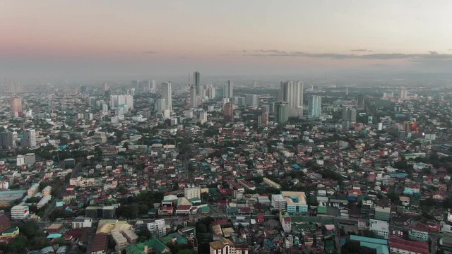 Aerial Drone shot of Cubao in Quezon City, Manila, Philippines while sunrise