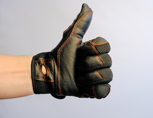 Hand with gestures in a leather glove