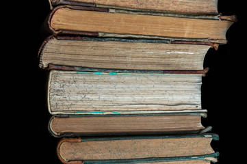 stack of old books on a library shelf