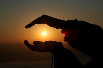 The sunrise In the winter morning, the hand holds the sunrise in the morning.