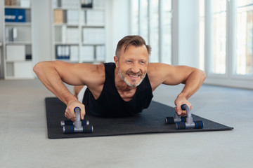 Determined middle-aged man working out in a gym