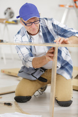 close-up a man building a furniture