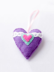 Toys made of felt on a white background, colored heart