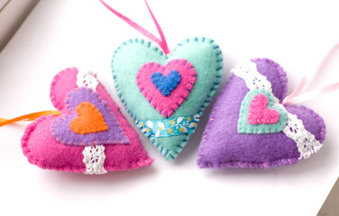 Toys made of felt on a white background, colored heart