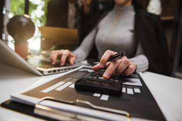 Team of business analysts discussing the business strategy in contemporary using on smartphone and tablet as concept