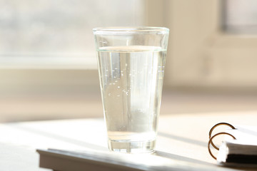 Glass of water on workplace in office