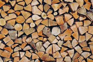 Stacked chopped wood. Delayed firewood for the winter. Wood background.	