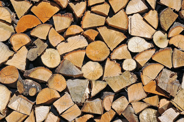 Stacked chopped wood. Delayed firewood for the winter. Wood background.	
