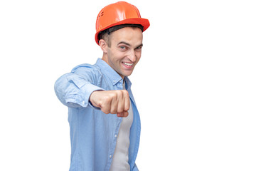 Joyful Builder in helmet shows fist to camera, isolated background, copy space