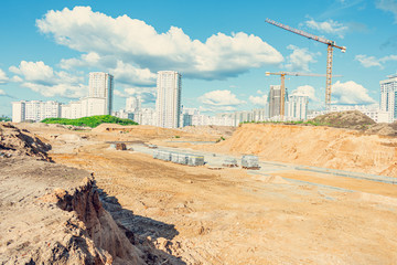 Construction of an apartment building, building cranes, blue sky with fluffy clouds