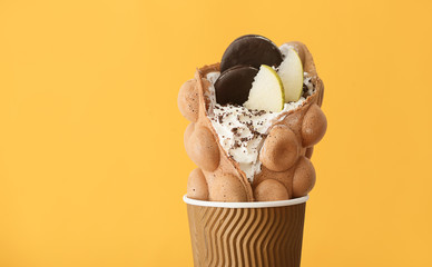 Delicious sweet bubble waffle on color background