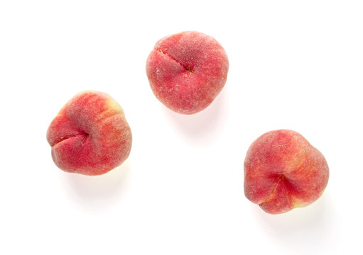 Fresh flat peach isolated on white background.