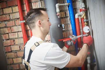 plumber installing water equipment - meter, filter and pressure reducer