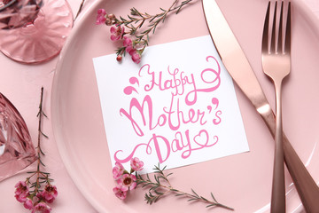 Table setting with card for Mother's day dinner, closeup