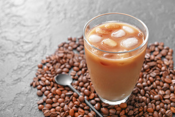 Glass of tasty iced coffee on dark background