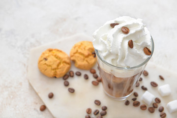 Glass of tasty iced coffee on table