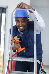 happy construction worker with a ladder