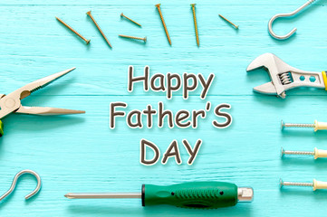 Working tools hammer wrench screwdriver top view on wooden background happy fathers day