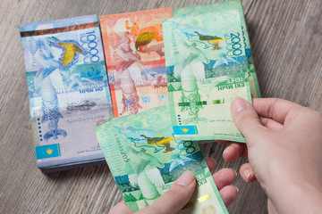 Hands hold a lot of money. Tenge KZT. National currency of Kazakhstan, KZ. Exchange rate. Economy, development, business, Bank, broker. Banknote	