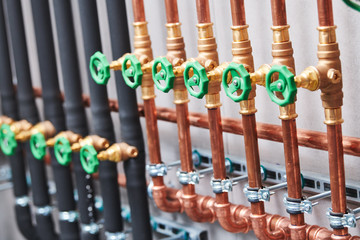 Plumbing service. copper pipeline of in boiler room. valves in row