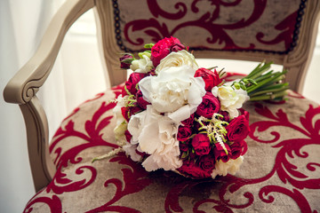 Beautiful tender bride's wedding bouquet made of peonies and alstromeries, closeup
