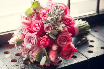 Beautiful tender bride's wedding bouquet on the windowsill