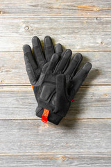Construction gloves on grey wooden background. Top view with space for text	