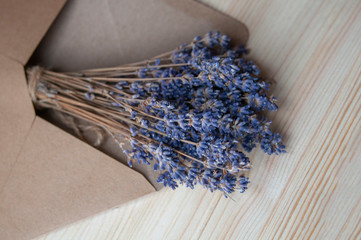 Bright lavander on wooden background with letter