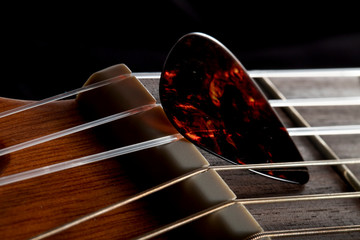 guitar playing pen on the strings closeup, macro look