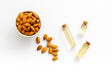 Skin care cosmetics. Almond oil in small bottles on white background top-down