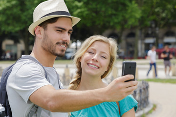 young couple taking selfie in the park