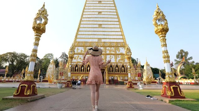 Woman walking Wat Phra That Nong Bua Travel Ubon Ratchathani, Thailand.