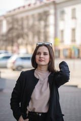 young woman in casual style on a city street. Portrait of a beautiful stylish woman. vertical photo