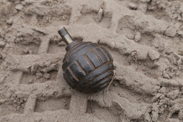 World War I hand grenade in the sand