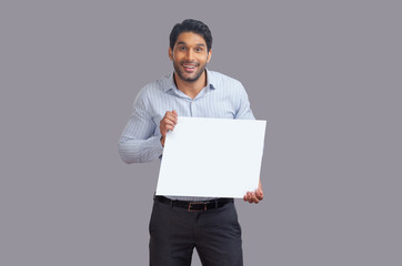 Man holding white square placard in his hand. 