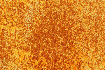 Old peeling cracked paint on an abandoned rusty sheet of metal. Abstract modern trendy red yellow rusty texture background