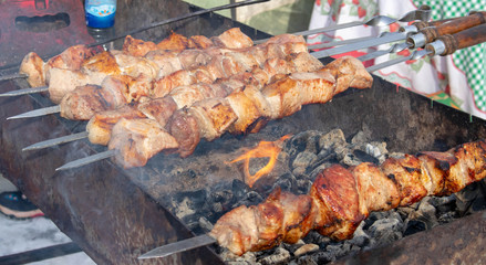Traditional Russian shashlik on a barbecue skewer, cooking outdoor activities meat on skewers. Shish kebab roasting on the grill.