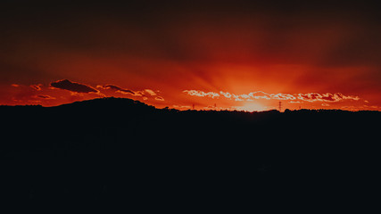 magical sunset on top of a hill in the middle of the natural and city