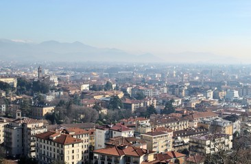 Fototapeta na wymiar Bergamo old Italian town medieval buildings urban panorama beautiful cityscape blue sky horizon mountains