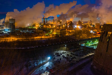Night top view of a steel mill. Smog, smoke and flame from the chimneys