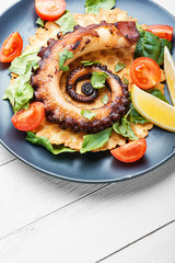 Vegetable salad with octopus.