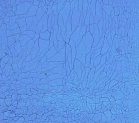  blue background made of cracked paint on the wall of the house